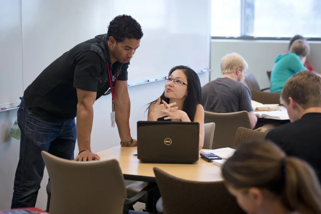 Tutor working with a student in the Excel Center